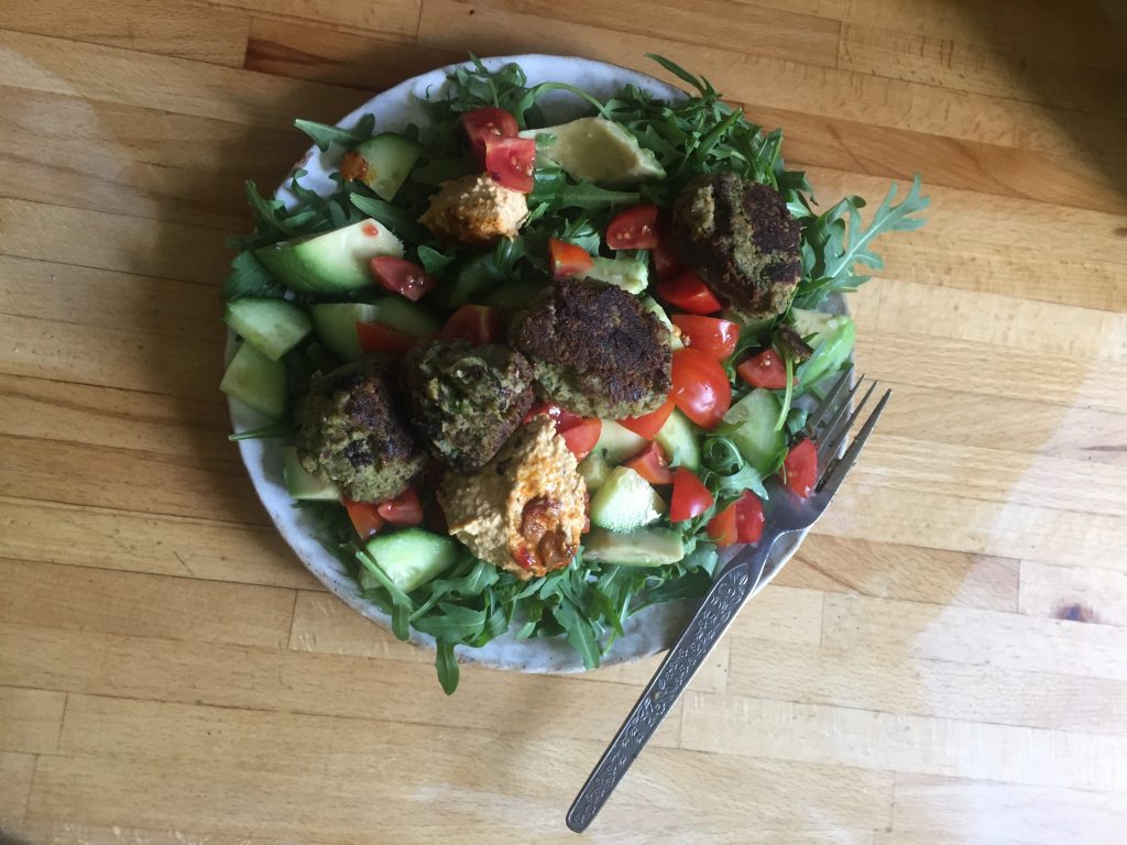 a picture of homemade falafel salad on a wooden work surface