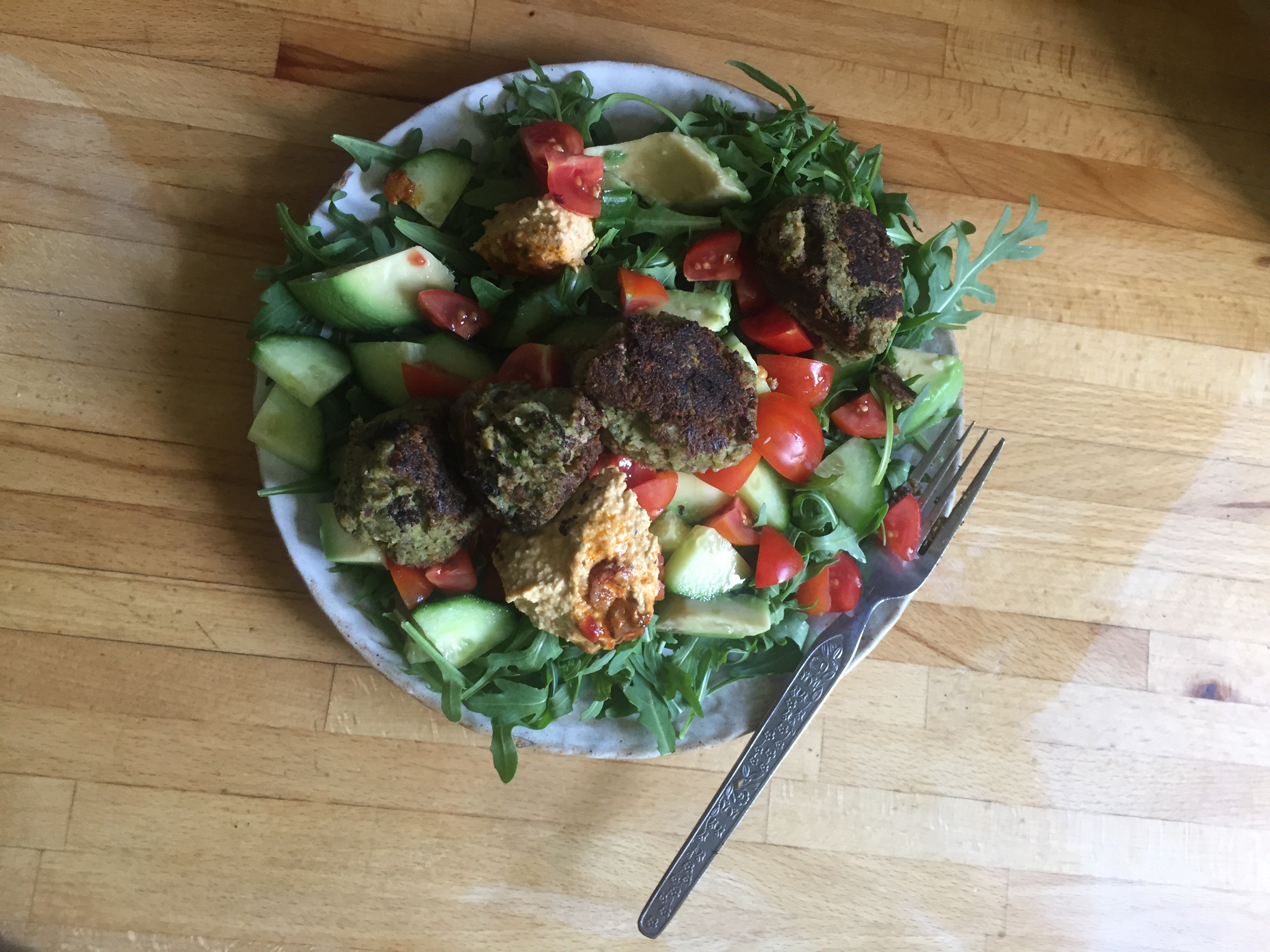 a picture of homemade falafel salad on a wooden work surface
